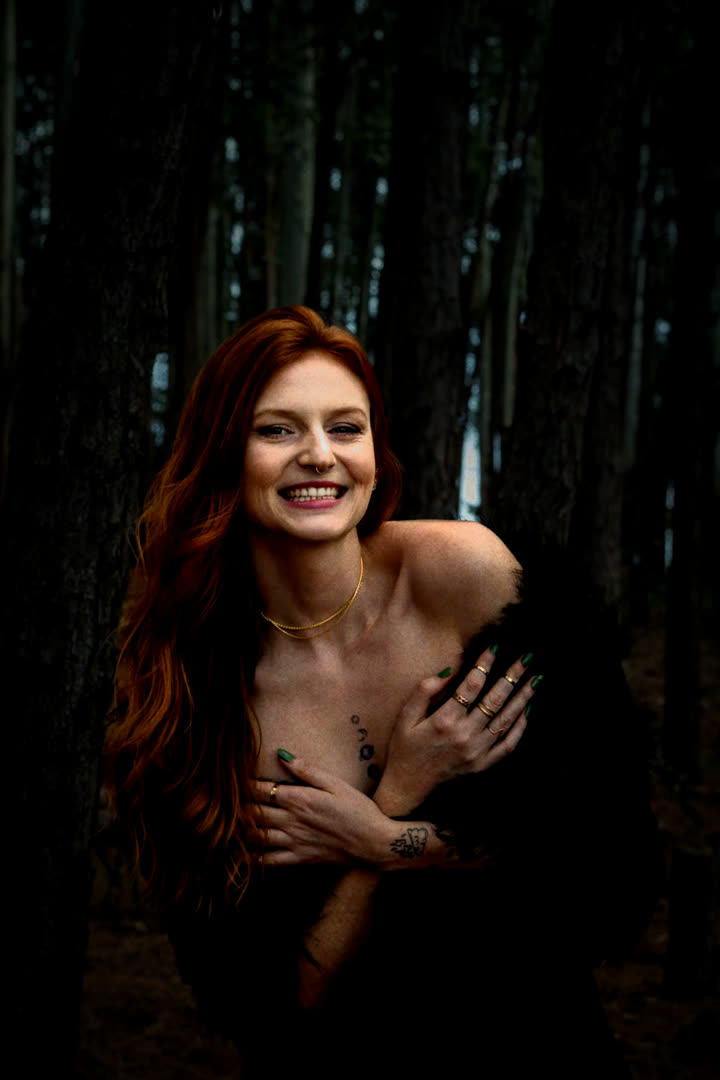 Luxe Compact with Flash: a woman lit by flash in a dark forest